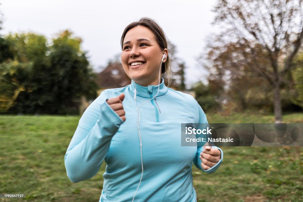 Young overweight chubby woman running